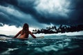 A girl in a bikini is laying on her surfboard Royalty Free Stock Photo