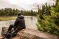 Girl sitting near Lake of two rivers in Algonquin National Park Canada Ontario natural pinetree landscape Royalty Free Stock Photo