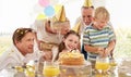 Girl, birthday cake and family celebrating a children event with food and a party outdoor. Happy smile of kids, father Royalty Free Stock Photo