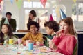 Girl With Birthday Cake And Party Blower At Party With Parents And Friends At Home Royalty Free Stock Photo