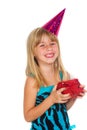 Girl with a birthday gift and cap Royalty Free Stock Photo