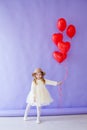 beautiful girl at birthday party with red balloons Royalty Free Stock Photo