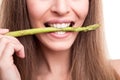 Girl biting asparagus Royalty Free Stock Photo