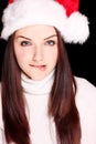 Girl biting her lip wearing Santa hat Royalty Free Stock Photo