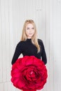 Girl in a black bodysuit and holding a red rose Royalty Free Stock Photo