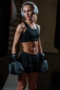 Girl in black boxing gloves posing in gym Royalty Free Stock Photo