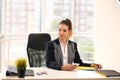 Girl in a black businesswoman jacket works in a bright office