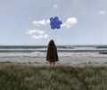 Girl in a black cloak holding balloons