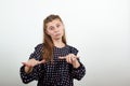 Girl in a black dress abruptly stretched out her arms and looks confident