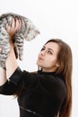 Girl in black dress holds a kitten in hands Royalty Free Stock Photo