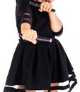 A girl in a black dress holds markers in her hands and shows her readiness to fight Royalty Free Stock Photo