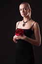 Girl in black dress with red rose