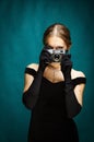 The girl in a black evening dress with a camera in her hands