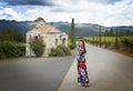 A girl in a black floral dress standing by the church Royalty Free Stock Photo