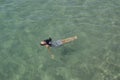 A Girl with black hair laying in the ocean