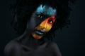 Girl with black make-up and colorful bodypainting