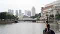 Girl in Black Sitting by Singapore River