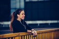 Girl in black sports outfit resting after running on the bridge, at night Royalty Free Stock Photo