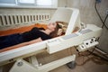 A girl in a black T-shirt lies in a hyperbaric chamber, oxygen therapy Royalty Free Stock Photo