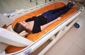 A girl in a black T-shirt lies in a hyperbaric chamber, oxygen therapy Royalty Free Stock Photo
