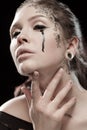 Girl with black tears from eyes and lace pattern on face and neck Royalty Free Stock Photo