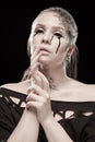 Girl with black tears from eyes and lace pattern on face and neck Royalty Free Stock Photo