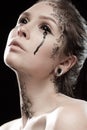 Girl with black tears from eyes and lace pattern on face and neck Royalty Free Stock Photo