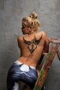 Girl with black temporary tattoo painted with paints for body art Royalty Free Stock Photo