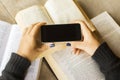 Girl with blank cell phone and books Royalty Free Stock Photo