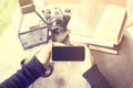 Girl with blank cell phone, books and old camera Royalty Free Stock Photo