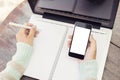 Girl with blank cell phone and diary Royalty Free Stock Photo