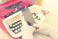 Girl with blank cell phone and typewriter Royalty Free Stock Photo