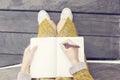 Girl with blank diary and pen sitting on wooden bench Royalty Free Stock Photo