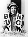 Girl with blocks spelling buy now Royalty Free Stock Photo