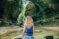 Girl with blond hair in boat on lake in Georgia, nature Martvili Canyon, active leisure for tourists, gorgeous bright