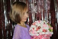 girl with blond hair with a bouquet of marshmallow flowers