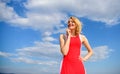 Girl blonde lady smiling enjoy warm sunlight blue sky with clouds background. Girl playful mood coquette. Sunlight Royalty Free Stock Photo