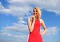 Girl blonde lady smiling enjoy warm sunlight blue sky with clouds background. Woman red dress feels carefree and free