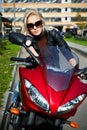 The girl blonde sg on red motorcycle Royalty Free Stock Photo