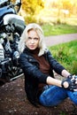 The girl the blonde sitting about a motorc Royalty Free Stock Photo