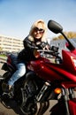 The girl blonde sitting on red motorcycle Royalty Free Stock Photo