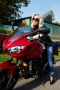 The girl blonde sitting on red motorcycle Royalty Free Stock Photo