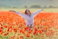 Girl at blooming poppy field