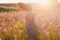 Girl on blooming Sally flower field. Lilac flowers and woman.