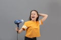 Girl blow-dry hair isolated on gray background