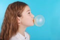 Girl blowing a big bubble gum bubble Royalty Free Stock Photo