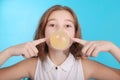 Girl blowing a big bubble gum bubble Royalty Free Stock Photo