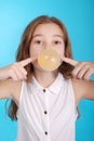 Girl blowing a big bubble gum bubble Royalty Free Stock Photo