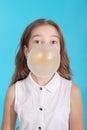 Girl blowing a big bubble gum bubble Royalty Free Stock Photo