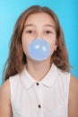 Girl blowing a big bubble gum bubble Royalty Free Stock Photo